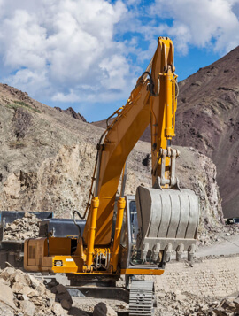 Excavator working on a mountain road construction