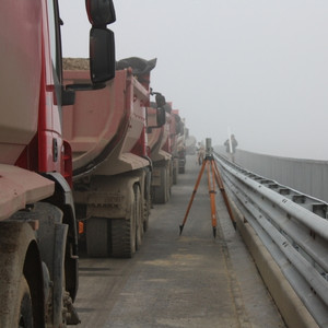 Trucks and survey equipment on a bridge deck